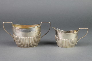 A Victorian silver demi-fluted cream jug and sugar bowl, Birmingham 1897, 128 grams
