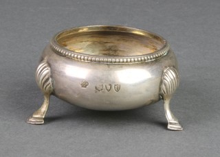 A Victorian circular silver table salt with shell knees and feet, London 1895 