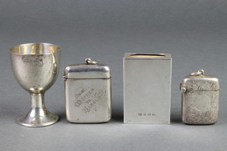 An Edwardian silver vesta with engraved decoration Birmingham 1901, 1 other, a match sleeve and an egg cup 