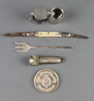 A silver medallion, pickle fork, cigar cutter, pen knife and magnifying glass 