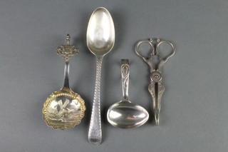 A Georgian silver dessert spoon, a childs spoon, a pair of nips and a Continental repousse spoon