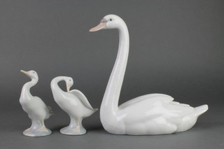 A Lladro figure of a seated swan. 5230 9" and 2 ditto figures of geese 5" and 4 1/2" 