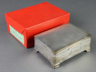 An engine turned silver cigarette box, Birmingham 1960, in original box