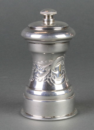 A silver plated repousse pepper mill