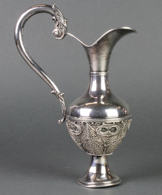 A Persian silver ewer with filigree decoration and extravagant handle, 208 grams