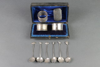 A silver vesta with chased decoration, 3 silver napkin rings and a set of 6 fancy silver leaf bowl spoons 