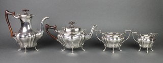 A silver 4 piece tea and coffee set with ebony mounts on hoof feet, Sheffield 1921, gross 2140 grams 