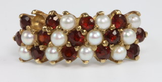 A 9ct gold garnet and pearl dress ring, size O