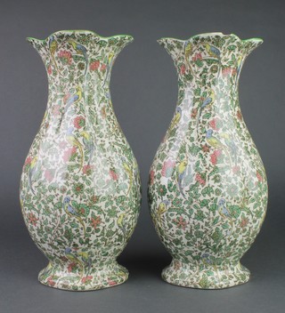 A pair of Royal Doulton persian flattened oviform vases decorated with budgerigars amongst flowers 13" 