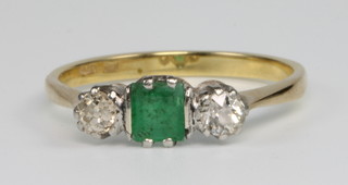 An 18ct yellow gold emerald and diamond ring, size M