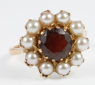 A 9ct gold garnet and pearl cluster ring, size O 1/2