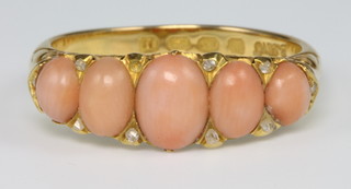 An 18ct yellow gold coral and diamond set ring, size Q 1/2