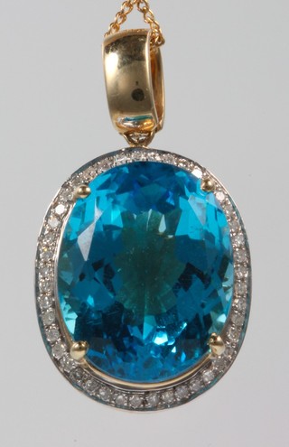 A 9ct gold chain with a14ct gold  blue topaz pendant 