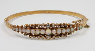An Edwardian 15ct gold opal and diamond set bangle, gross 16 grams