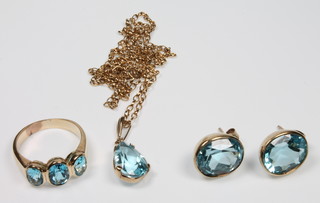 A 9ct gold blue topaz pendant, ring and earrings, ring size J 