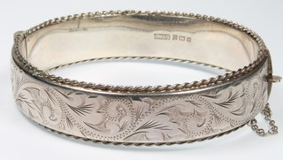 A silver chased bangle