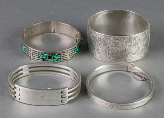 A wide silver bangle and 3 others