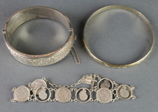 A silver chased bangle, 1 other, a necklace and a coin bracelet
