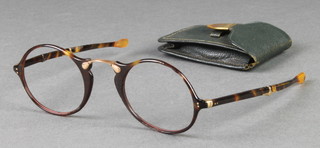 A pair of Edwardian gilt mounted folding tortoiseshell spectacles in a leather case 