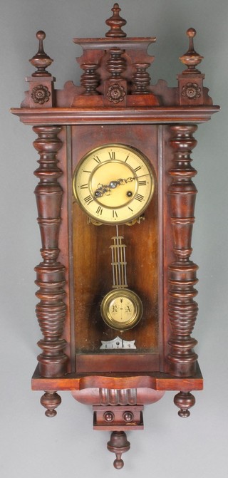 A Vienna style striking regulator with paper dial and gridiron pendulum contained in a walnut case