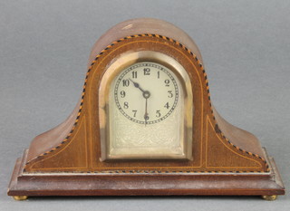 A bedroom timepiece with arched silvered dial and Arabic numerals contained in an inlaid oak arch shaped case 4"h