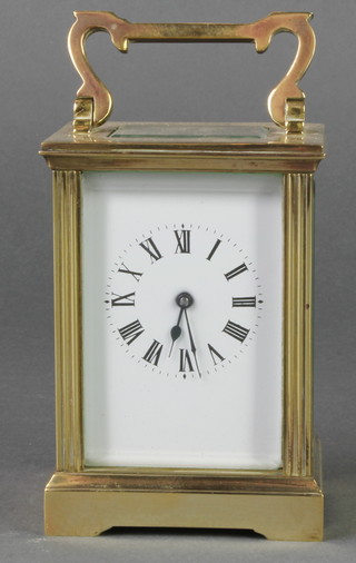 A 19th/20th Century French 8 day carriage timepiece with enamelled dial and Roman numerals contained in a gilt metal case 4 1/2"h