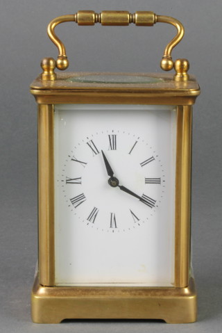 A French 19th Century 8 day carriage timepiece with enamelled dial and Roman numerals contained in a gilt metal case 4 1/2"h