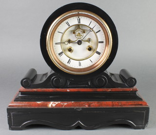 A Victorian French 8 day striking mantel clock with enamelled dial, Roman numerals and visible escapement, contained in a 2 colour marble case 