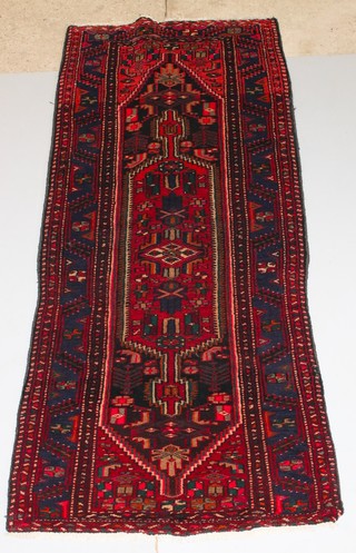A red and blue ground Afghan rug with diamond shaped lozenge to the centre 100" x 46" 