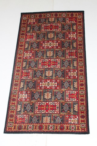 A machine made Persian style rug with all-over geometric design 71" x 37" 