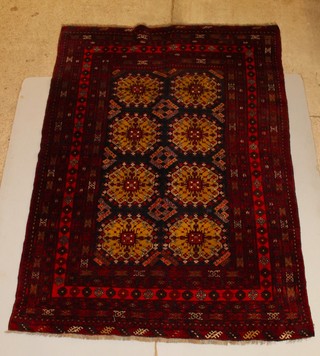 A red ground Afghan carpet with 8 octagons to the centre 112" x 78" 