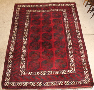 A red ground Afghan carpet with 21 octagons to the centre 142" x 107" 