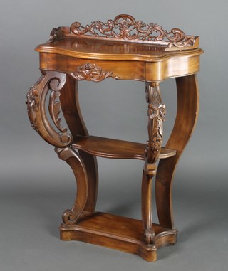 A 19th Century Continental mahogany console table of serpentine outline, the raised back with pierced and carved three-quarter gallery, fitted a drawer above 2 shelves, raised on scrolled supports 39"h  x 28"w x 30"d 