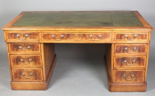A figured walnut kneehole pedestal desk with green inset writing surface above 1 long and 8 short drawers 28"h x 59"w x 32"d 