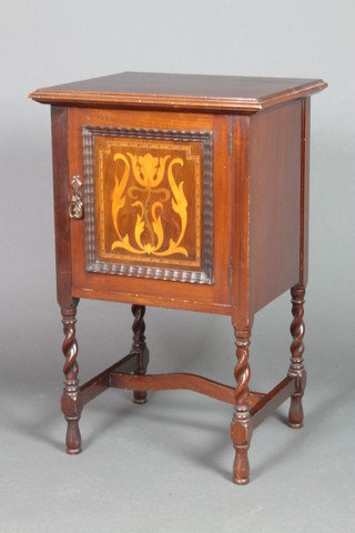 An Art Nouveau inlaid mahogany bedside cabinet enclosed by a panelled door, raised on spiral turned supports with H framed stretcher 29 1/2"h x 18"w x 16"d 