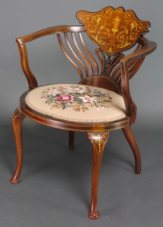 An Edwardian inlaid mahogany tub back chair with Berlin wool work seat raised on cabriole supports 