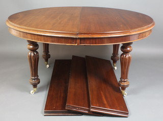A Victorian oval mahogany extending dining table, raised on 4 turned and reeded supports together with 3 later leaves 29 1/2"h x 47"w x 56"l when closed x 100" when extended