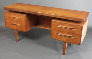 A 1960's G Plan teak dressing table fitted a vanity drawer above a recess above 4 short drawers, raised on turned tapered supports 27 1/2"h x 60"w x 18"d 