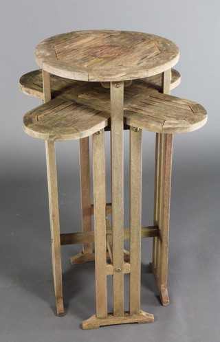 An Art Nouveau style  circular teak slatted garden occasional table on pierced panelled supports 32"h x 24"w x 23"d 