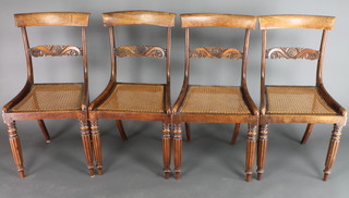 A set of 4 Georgian mahogany bar back dining chairs with carved mid rails and woven cane seats, raised on reeded supports 