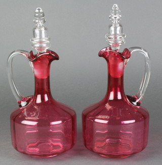 A pair of Victorian cranberry glass ewers with glass stoppers 10 1/2" 