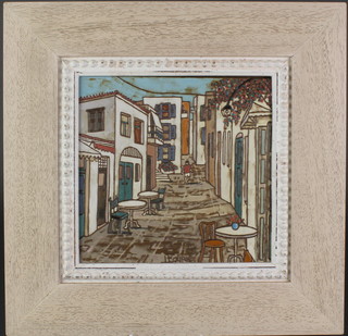 A framed tile depicting a European village scene 9 1/2" x 9 1/2" 