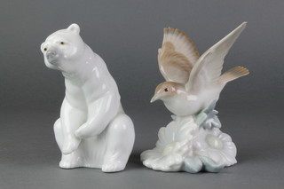 A Lladro figure of a seated Polar Bear 5", a ditto of a bird with outstretched wings 5" 