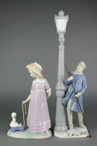 A Lladro figure of a lamp lighter 8", a ditto figure of a girl pulling a doll in a cart 11" 