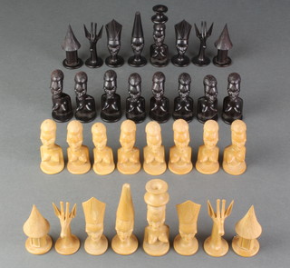 An African carved hardwood chess set in the form of figures together with a 10th edition of "The Beginners Book of Chess" 