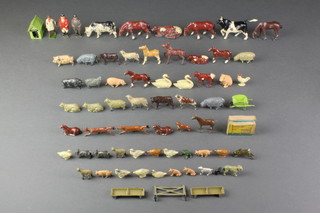A metal toy dog kennel with dog, 2 metal farm troughs, a wheelbarrow, a metal fence, 2 wooden boats together with a Britons figure of a shepherd, ditto huntsman and farmer and 58 various animal figures 