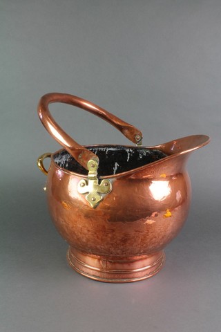A copper helmet shaped coal scuttle with swing handle 14"