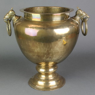 An Indian gilt metal twin handled urn with elephant ring drop handles, raised on a spreading foot 15"h 