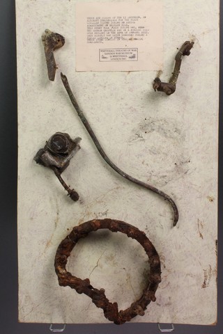Various parts recovered from the crashed L3 Zeppelin mounted on a cardboard panel and with Whitehall Theatre of War museum stamp 24" x 13 1/2" 