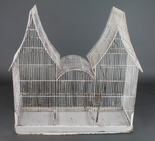 A 19th/20th Century wire work bird cage in the form of a double roofed pavilion 38 1/2"h x 21"w x 14 1/2"d